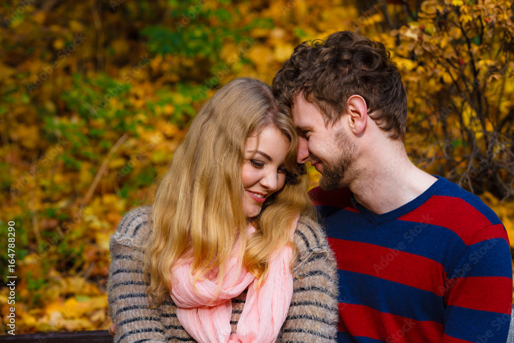 Lovers couple in autumn park on bench Lovers couple in autumn park on bench