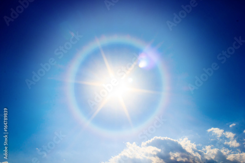 Beautiful fantastic sun halo phenomenon in sky, Miraculous sun with circular rainbow.