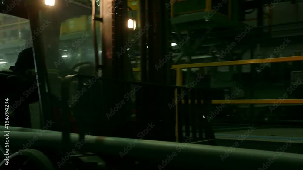 Forklift moving inside warehouse Forklift moving inside warehouse