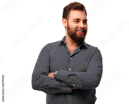 Portrait of bearded, smiling male with crossed arms.