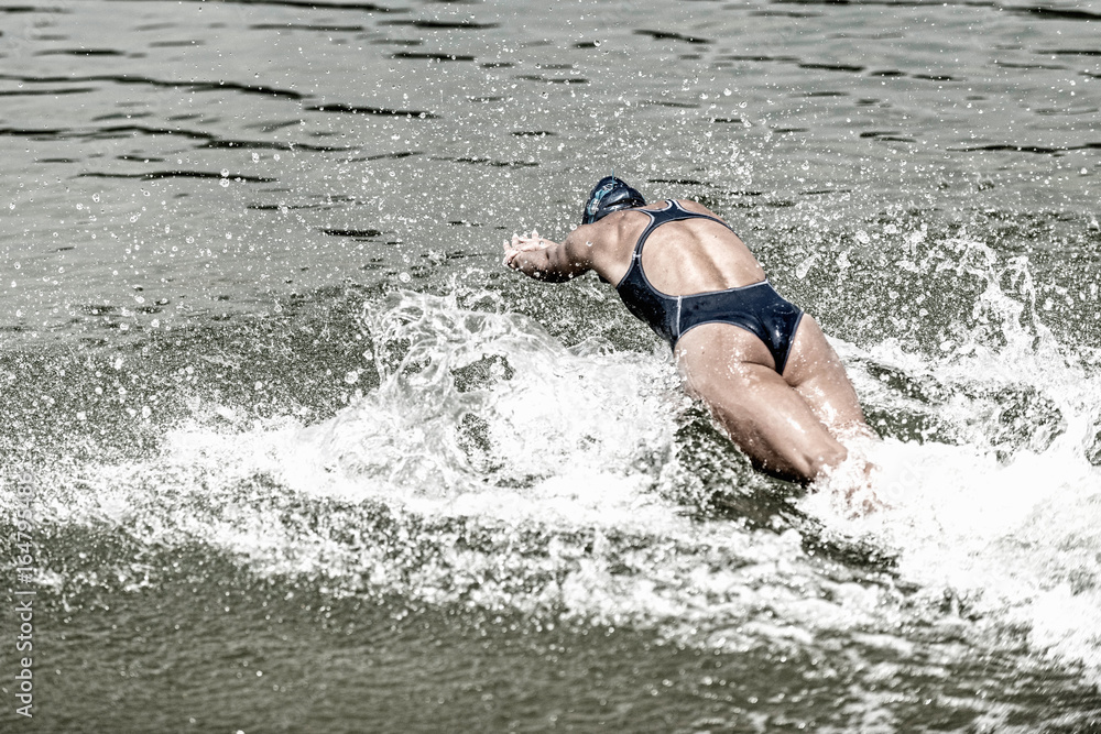 Fototapeta premium Triathlete rushing into the water