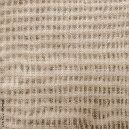 Hessian sack cloth texture canvas fabric pattern background in light aged sepia cream brown color