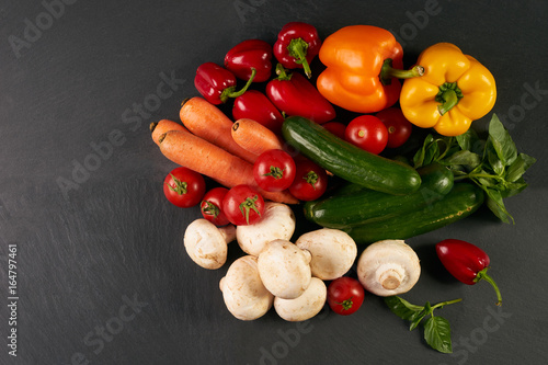 Close-up of a fresh delicious ingredients for healthy cooking or salad making on rustic background, top view, banner. Diet or vegetarian food concept.