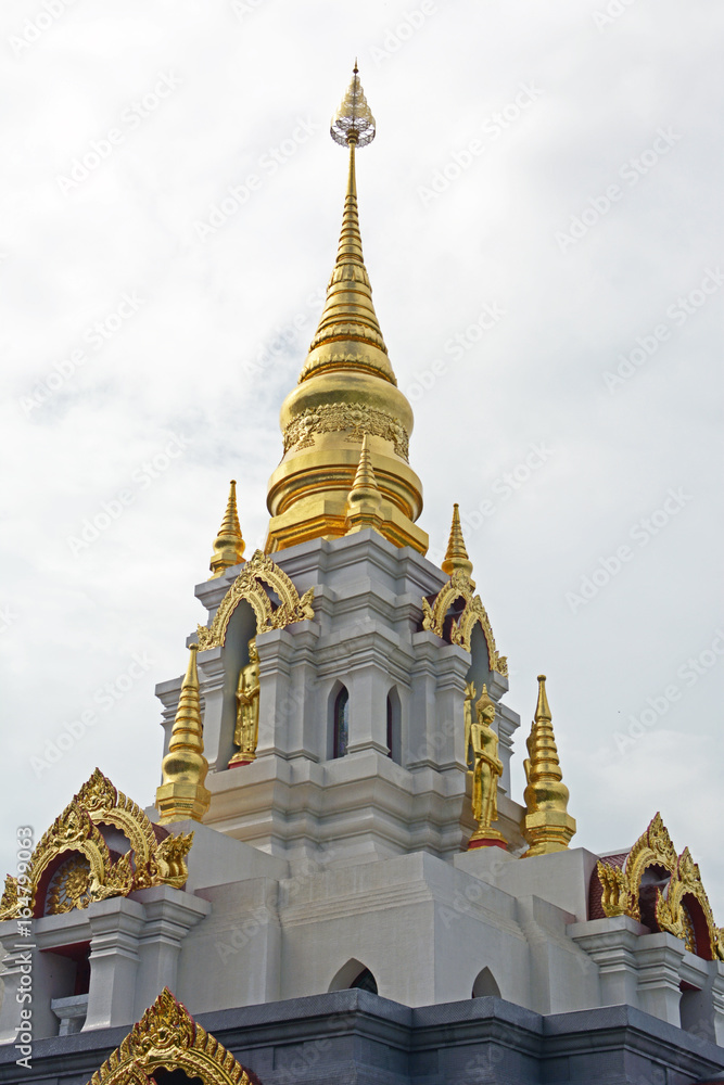 Top of thai temple in cloudy sky
