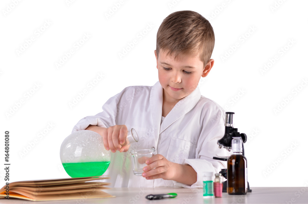 Science boy pours green liquid from flask into glass Science boy pours green liquid from flask into glass
