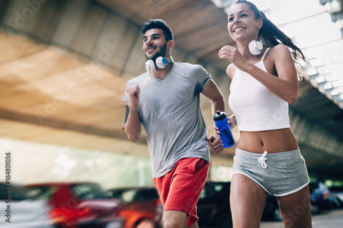 Attractive man and beautiful woman jogging together