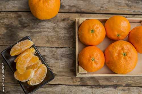 Mandarin Oranges - mandarin oranges on a rustic wooden board.
