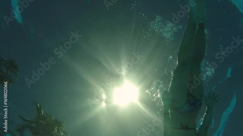 Wallpaper Mural woman swimming backstroke above camera, bottom view Torontodigital.ca