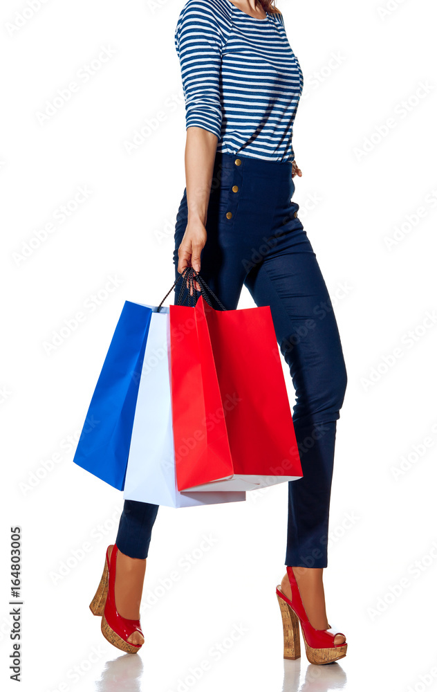 Closeup on fashion-monger walking with shopping bags on white Closeup on fashion-monger walking with shopping bags on white