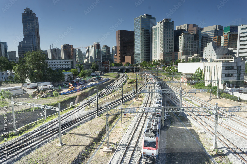 train at the railway station. Turning on train headlights. Big Railroad at the centre of the city. Industrial landscape. Big city. Seoul, South Korea train at the railway station. Turning on train headlights. Big Railroad at the centre of the city. Industrial landscape. Big city. Seoul, South Korea
