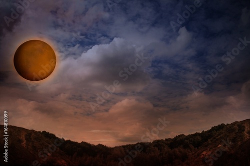 Moon eclipse - planet red blood with clouds . Beautiful sunset with moon 