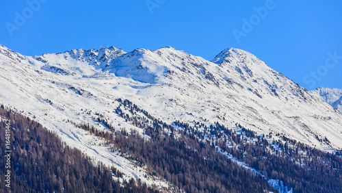 Summits of the Swiss Alps as seen from Davos in winter © photogearch