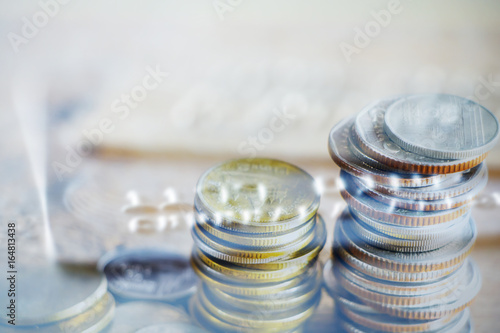 Double exposure Rows of coins of Credit cards on the table finance and business concept Money soft focus and blurred style dark tone.