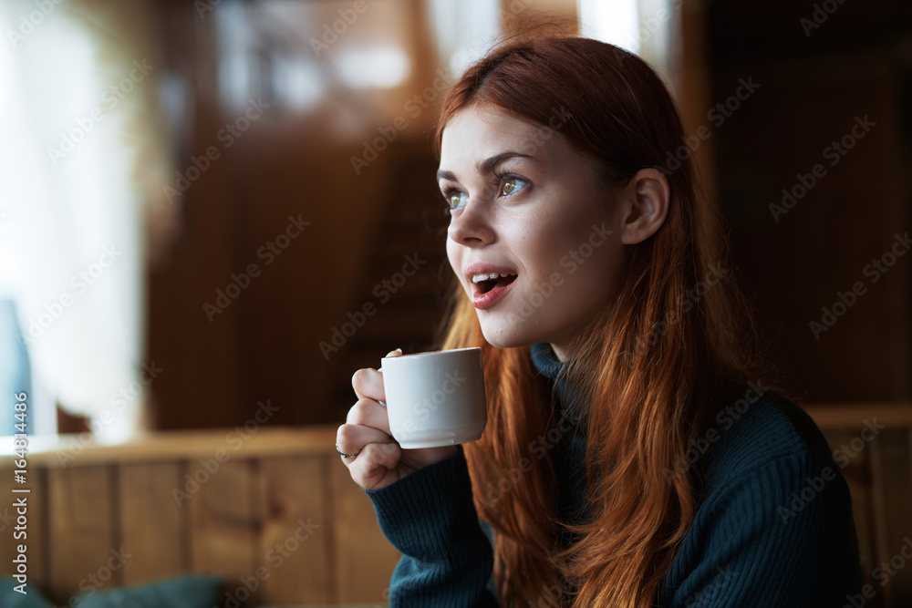 Beautiful young woman drinks coffee in a cafe Beautiful young woman drinks coffee in a cafe