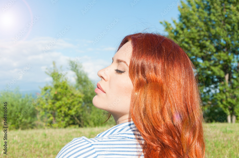 Red haired female loving to stay in the nature