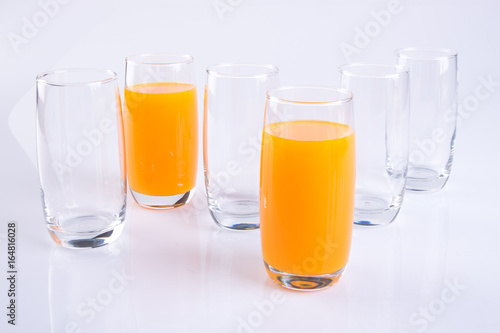 Orange juice in glasses on white background.