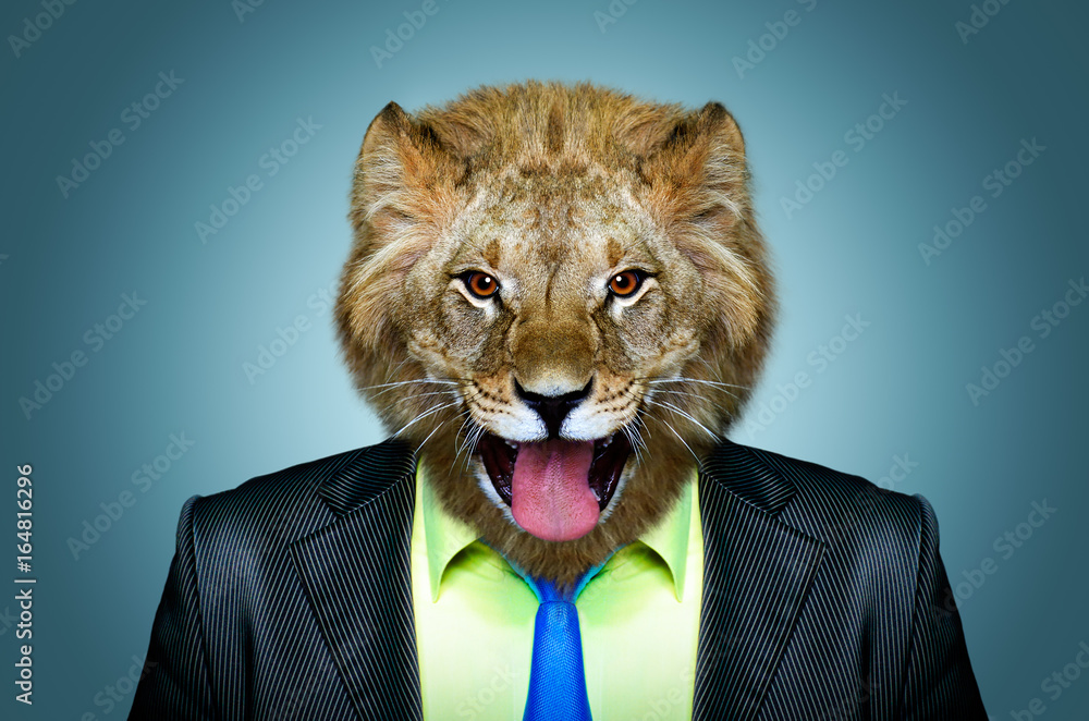 Fototapeta premium Portrait of a lion in a business suit on a blue background