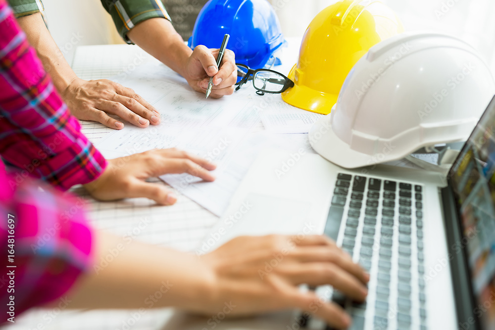 Engineer working on construction project,helmet and laptop on the table. Engineer working on construction project,helmet and laptop on the table.