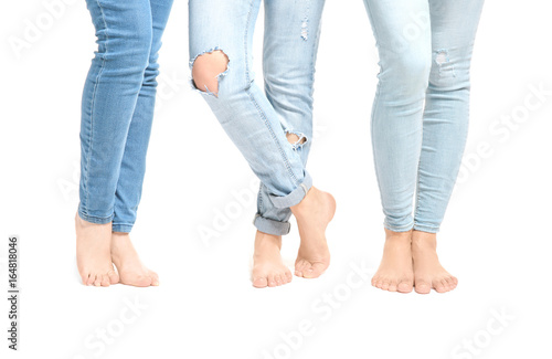 Beautiful female legs in jeans isolated on white