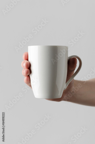 Mug Mock-Up - Male hands holding a mug on a gray background