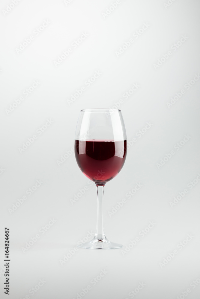 close-up view of wineglass full of red wine isolated on white close-up view of wineglass full of red wine isolated on white