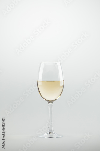 close-up view of wineglass full of white wine isolated on white