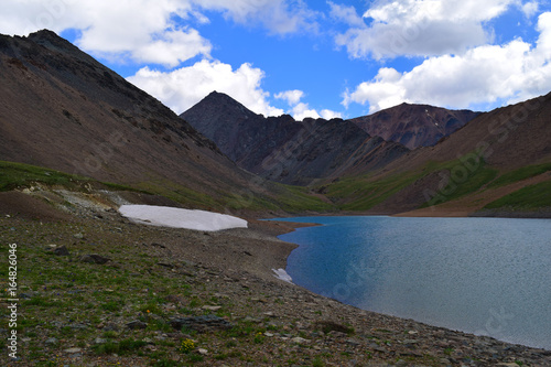 Lake with blue water and snow in Altai mountains