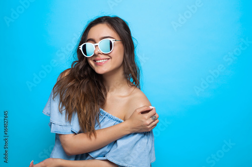 Girl wearing sunglasses and blue dress