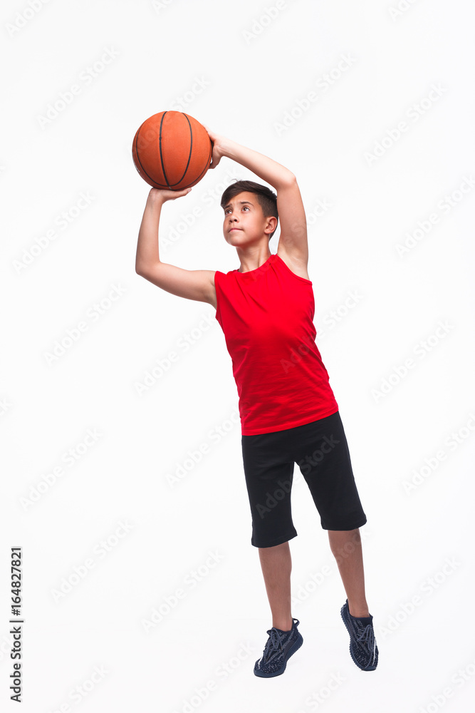 Teen basketball player throwing a ball