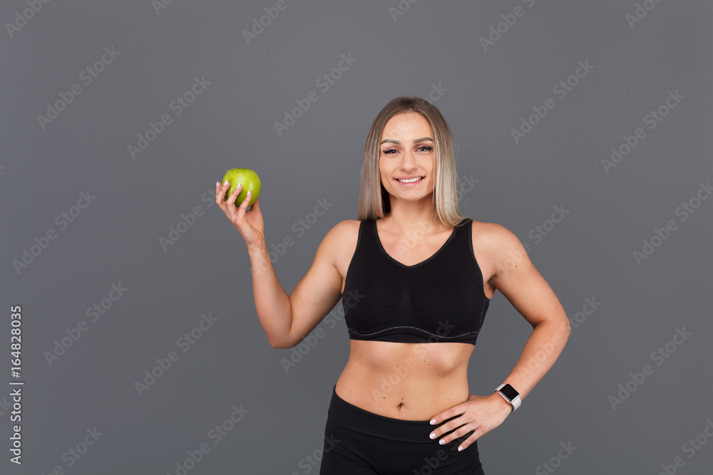 Fit woman posing with apple Fit woman posing with apple