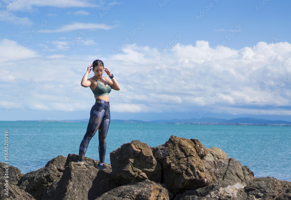 sporty beautiful happy girl poses on the beach