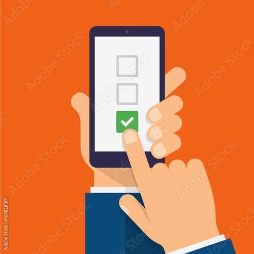 Checkboxes and checkmark on smartphone screen. Hand holds the smartphone and finger touches screen. Checklist modern flat design illustration. photo
