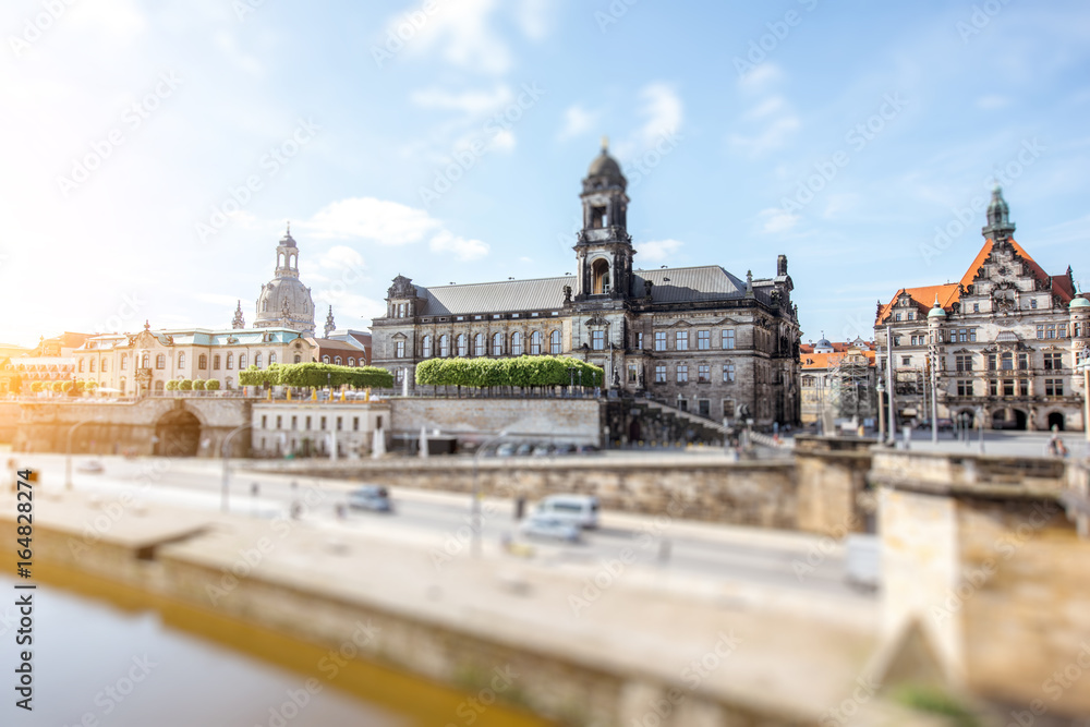 View on the riverside of Elbe river with beautiful buildings and church dome during the sunny weather in Dresden city, Germany. Tilt-shift image technic