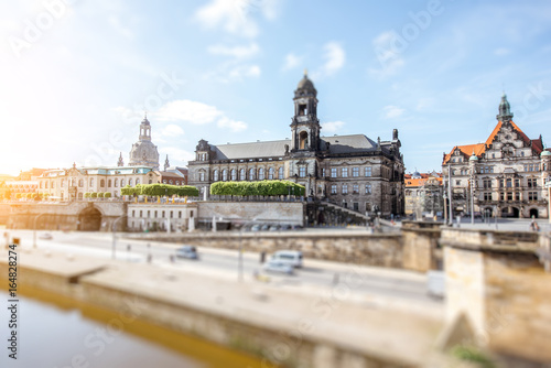 View on the riverside of Elbe river with beautiful buildings and church dome during the sunny weather in Dresden city, Germany. Tilt-shift image technic
