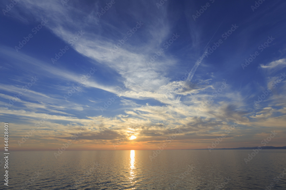 Sky and sea in the sunset, Beautiful colorful sunset with reflection, Dramatic sky background