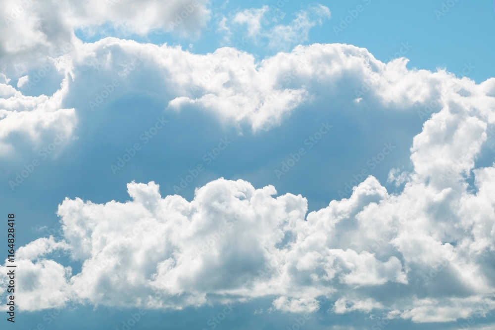 A blue sky with beautiful large fluffy clouds on a sunny and clear day. A blue sky with beautiful large fluffy clouds on a sunny and clear day.