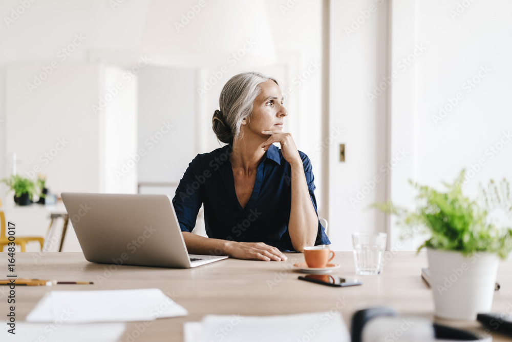 Businesswoman working on laptop in office Businesswoman working on laptop in office