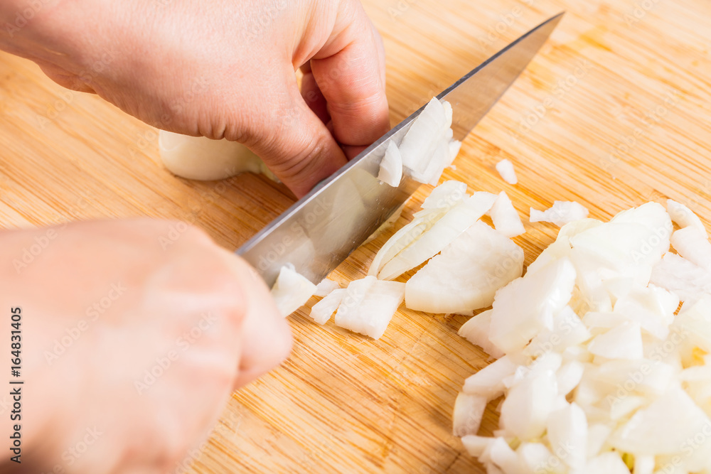 Cook cuts onions with a knife Cook cuts onions with a knife