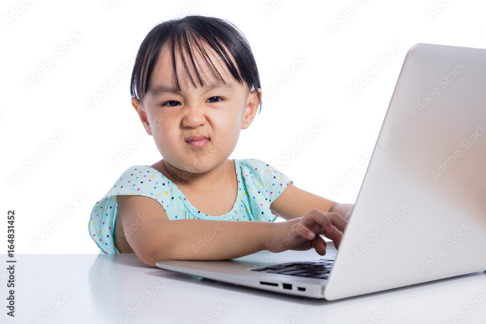 Asian Chinese little girl playing with laptop Asian Chinese little girl playing with laptop
