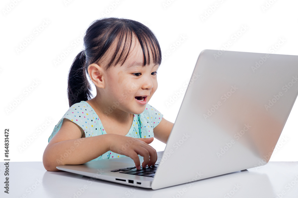 Asian Chinese little girl playing with laptop Asian Chinese little girl playing with laptop