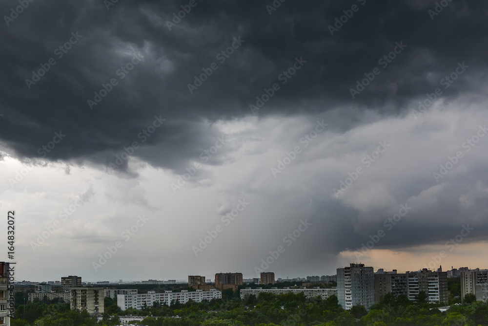 Dark storm cloud over city