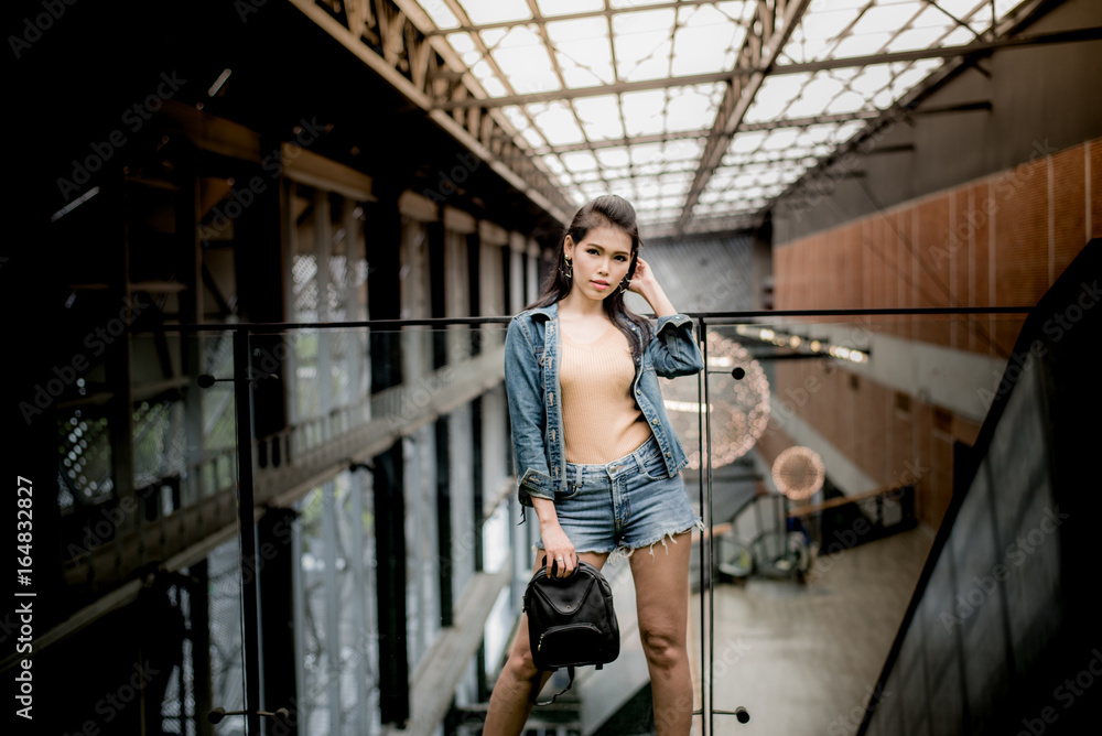 lifestyle fashion portrait of Asia woman in blue jeans