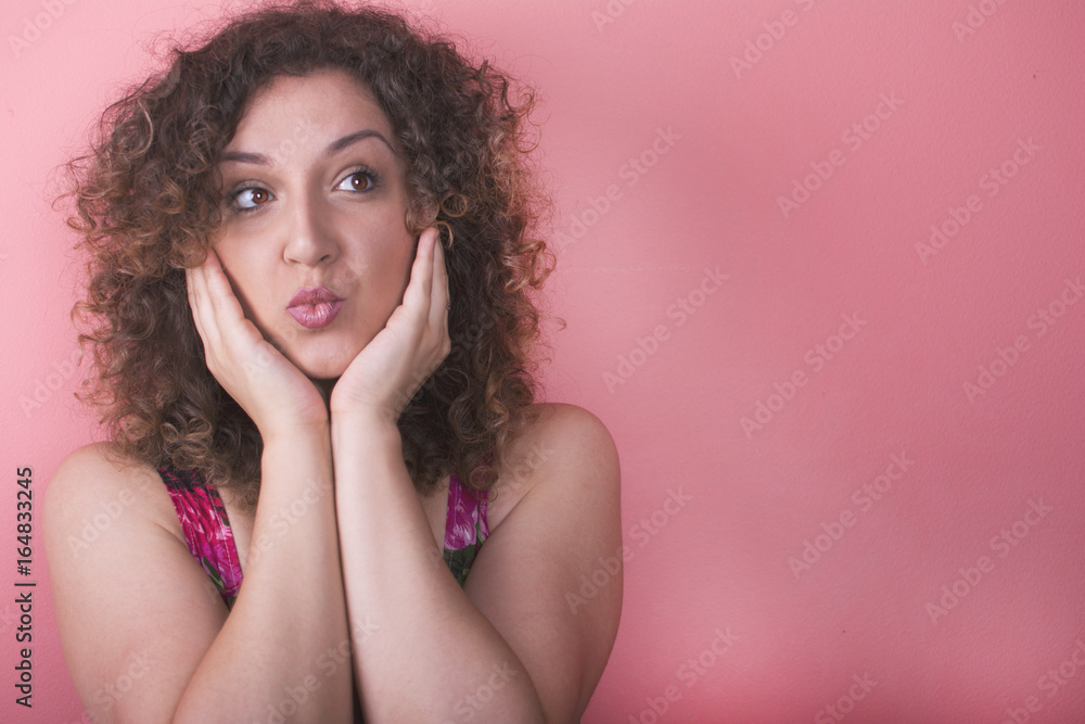 Beautiful elegant young woman in a pretty dress with flowers posing over pink background. Fashion spring summer photo. Beautiful elegant young woman in a pretty dress with flowers posing over pink background. Fashion spring summer photo.