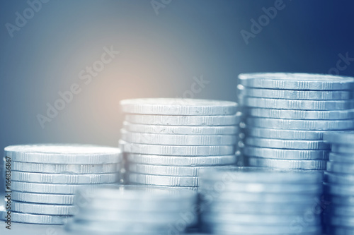 Row of coins on wood background for finance and Saving concept,Investment, Economy, Soft focus and dark style.