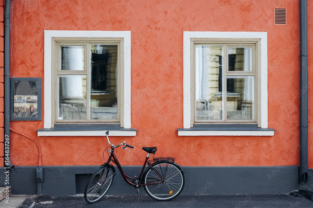 the bike on the background of red walls with white Windows