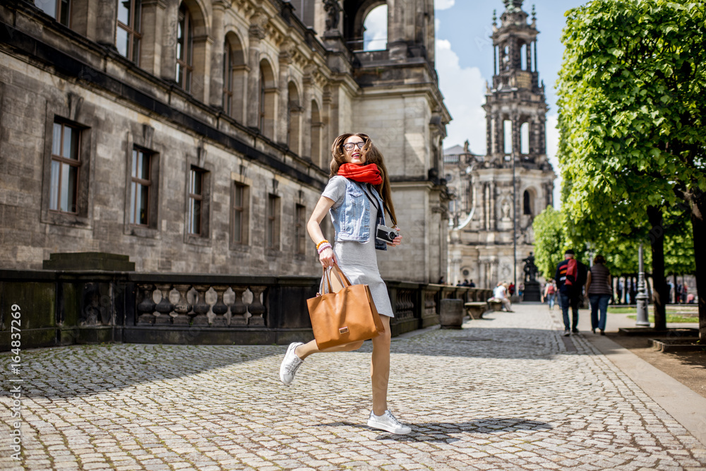 Lifestyle portrait of a businesswoman walking on the Bruhl terrace in Dresden, Germany