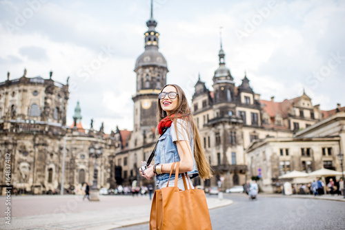 Young woman with photocamera walking on the Theaterplatz in Dresden, Germany © rh2010