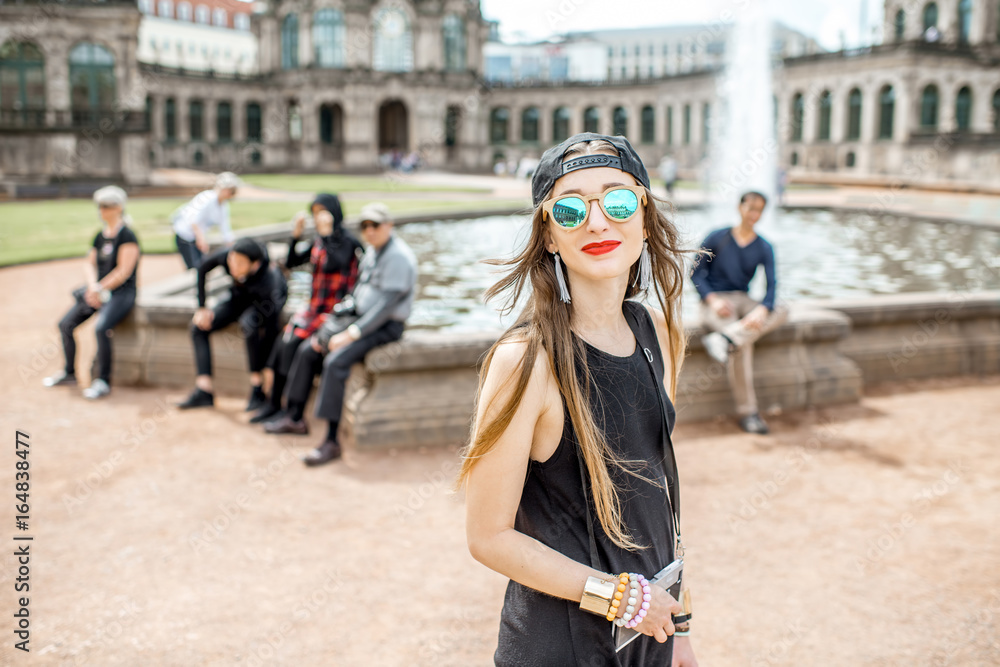 Fototapeta premium Young woman tourist walking with photo camera near the fountain in the old town of Dresden, Germany