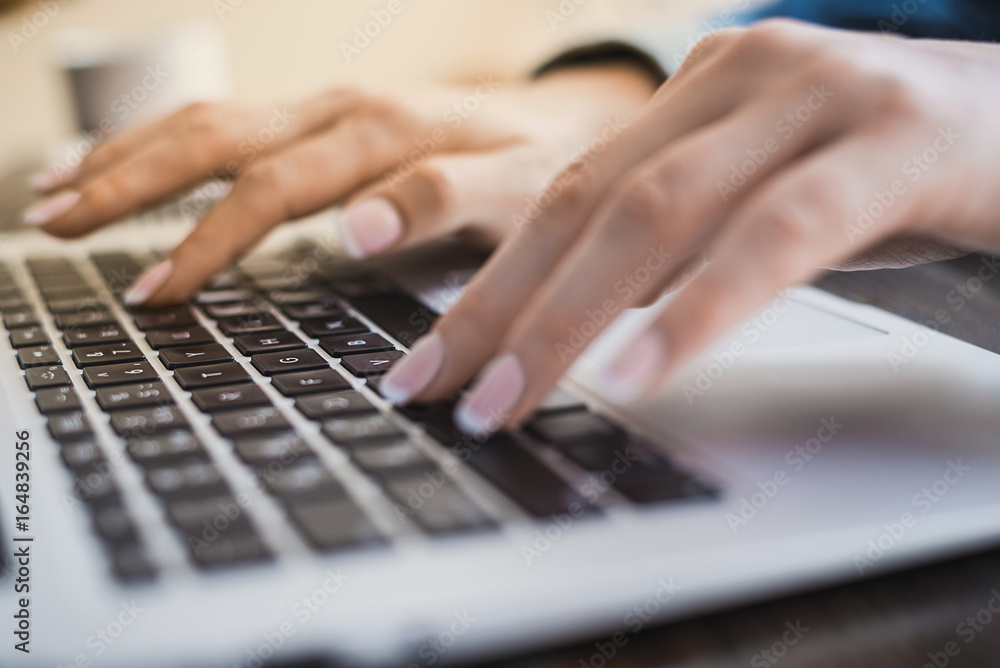 Morning business woman. Female hands working on a laptop, close-up. Horizontal frame