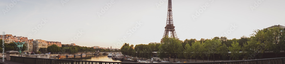 Fototapeta premium Famous Paris tower named Eiffelin the sunrise from the bridge.